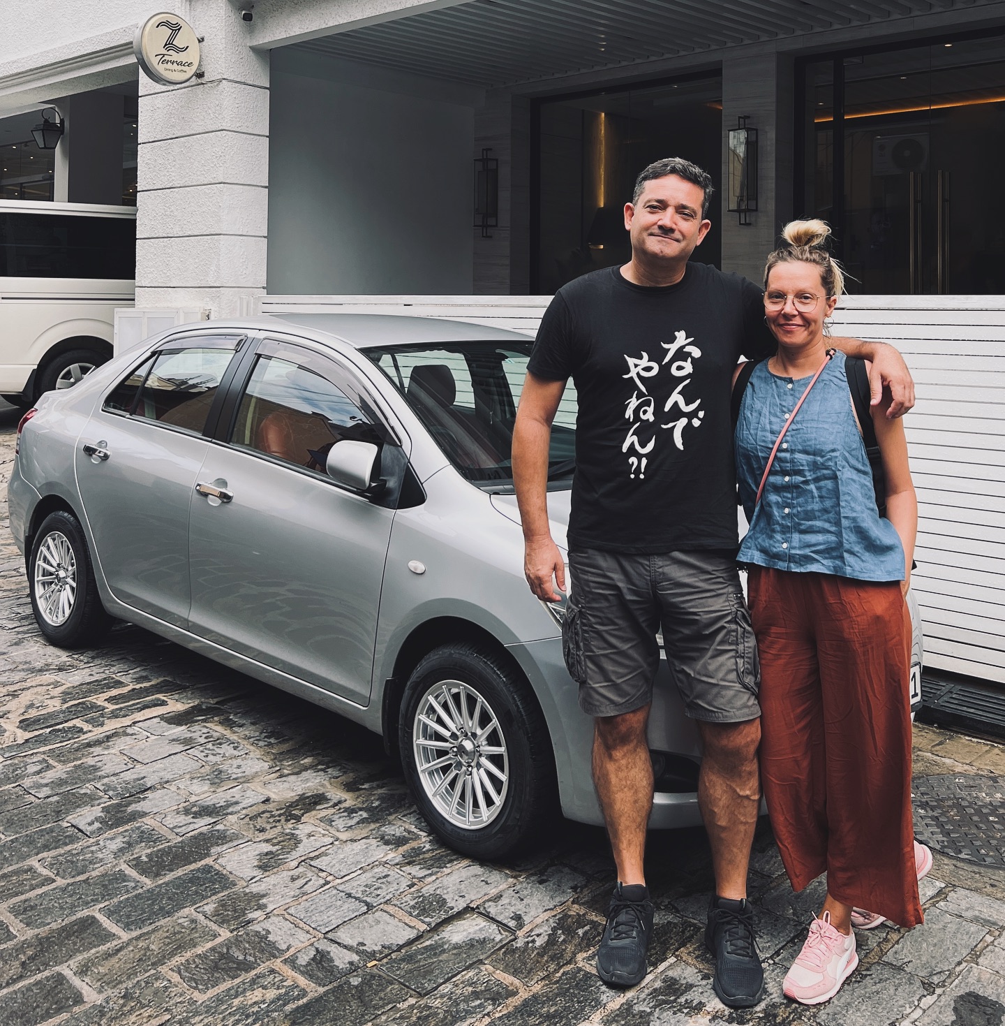 Couple with car at hotel