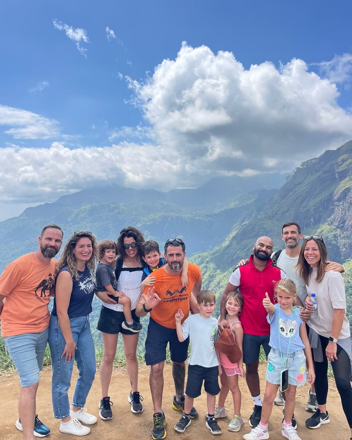 Happy tour group at scenic mountain viewpoint