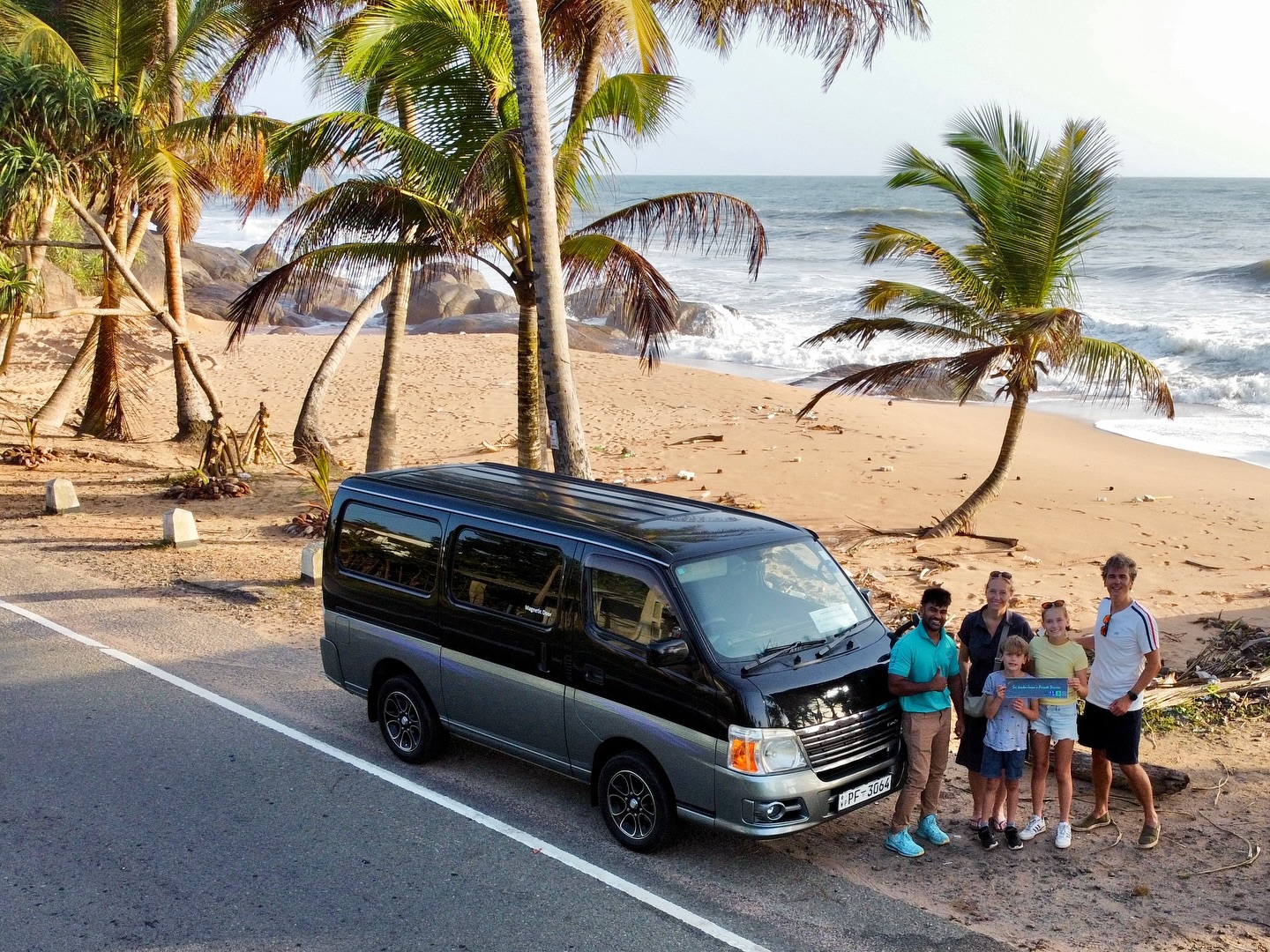 Family with tour van on coastal road