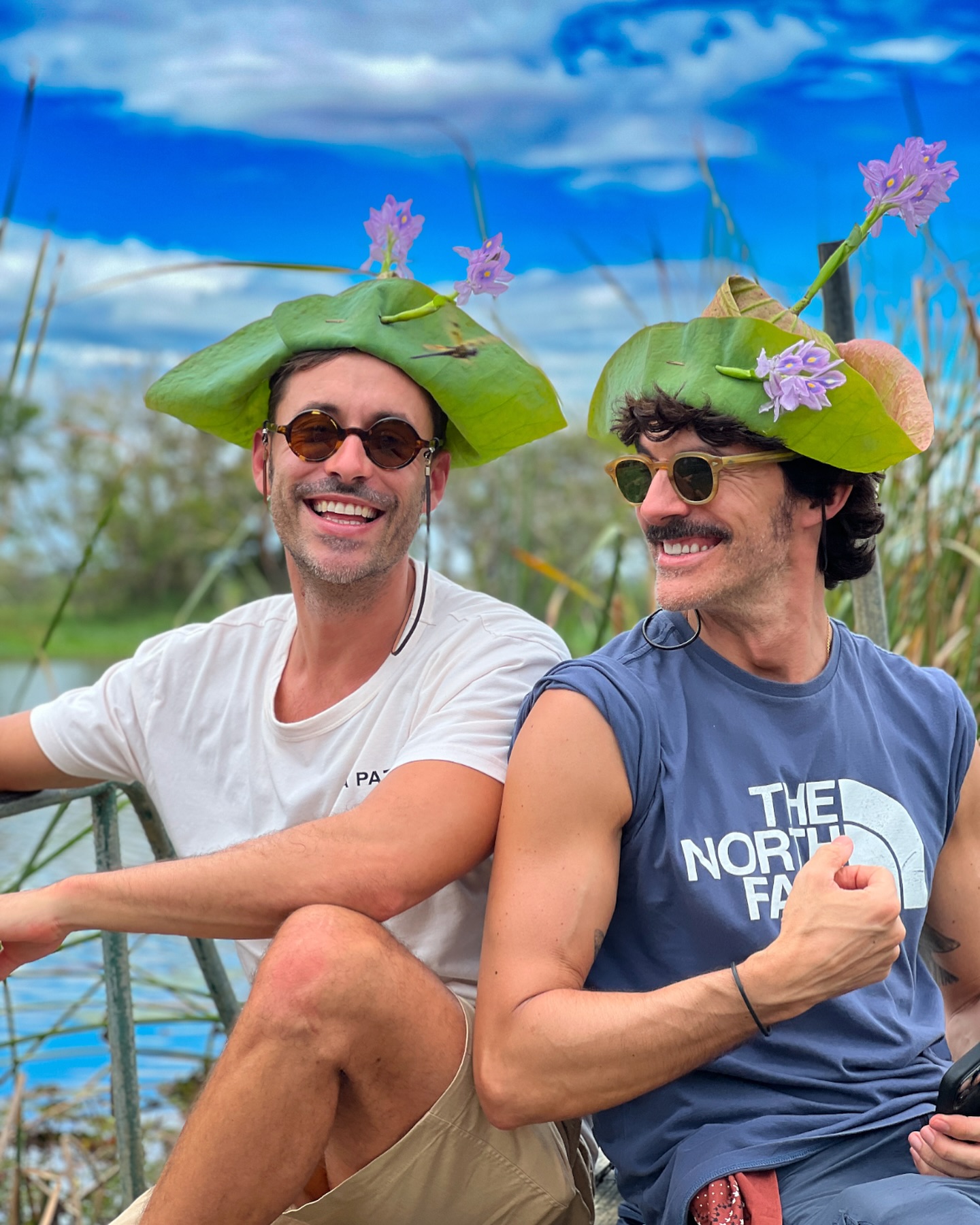 Tourists having fun with lily pad hats